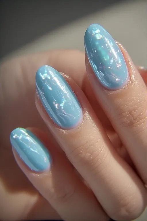 Alt text: sky blue glazed almond nails