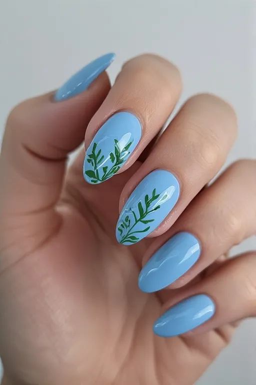 sky blue almond nails with green leaf accent