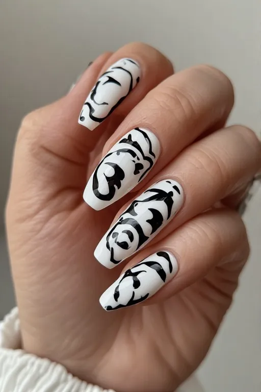 white nails with bold black swirl nail art