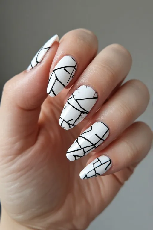 white nails with black geometric nail art