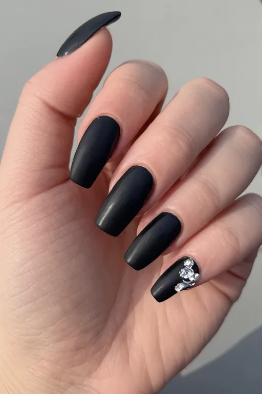 black matte nails with single rhinestone accent