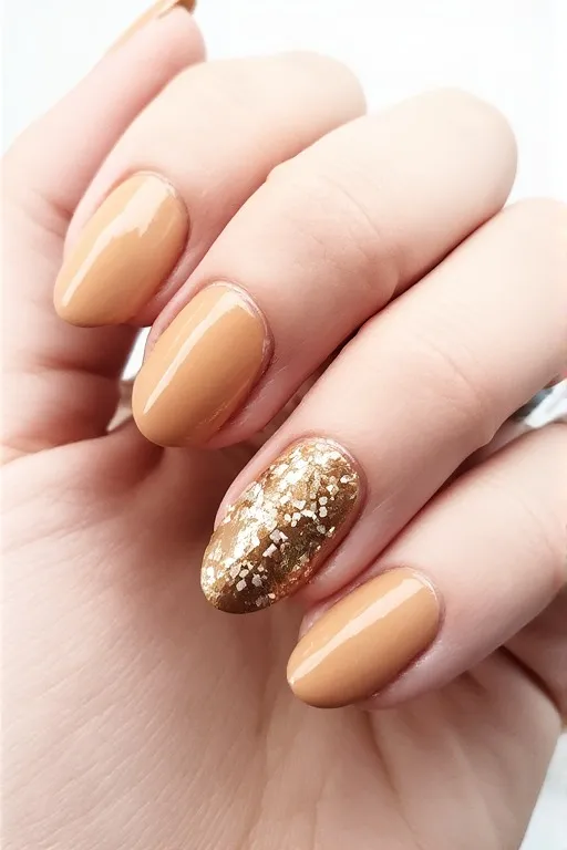 nude nails with gold foil accent