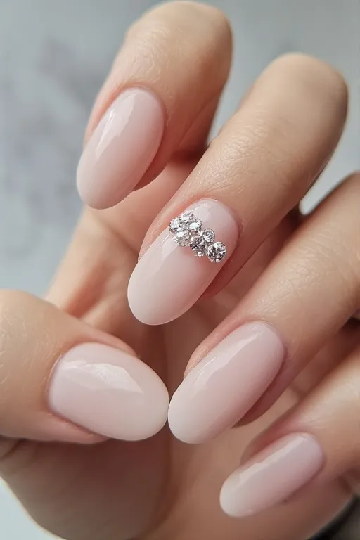  sheer nude nails with rhinestone accent