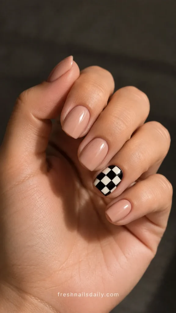 
nude short square nails with checkered accent