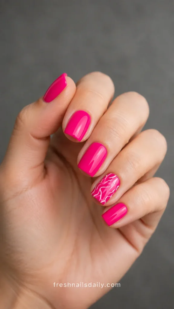 
hot pink short square nails with white squiggly lines