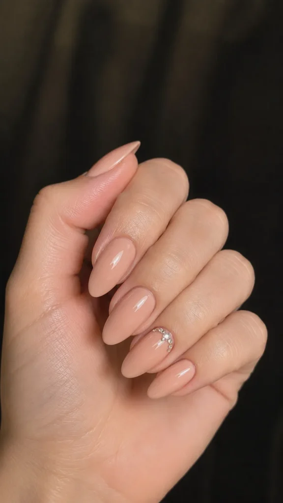 nude almond nails with rhinestone cuticle detail