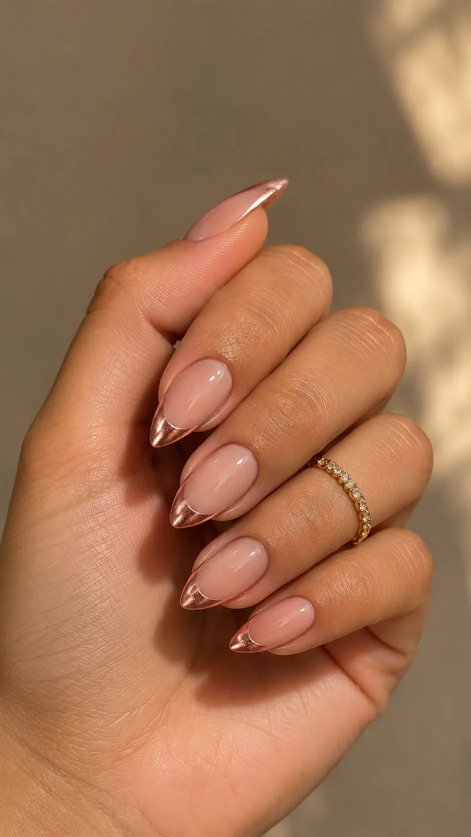 glazed nude almond nails with rose gold tips
